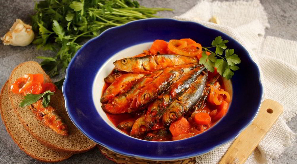 Рыбная тушёнка в томатном соусе на тарелке